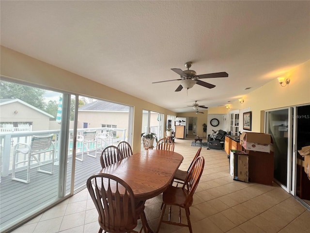 7941 Sycamore Dr, New Port Richey, FL 34654 - dining room featuring a ceiling fan, light tile patterned floors, and vaulted ceiling