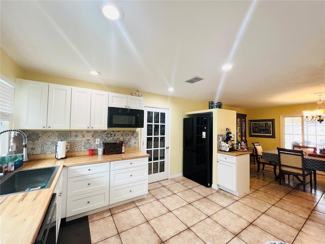 7941 Sycamore Dr, New Port Richey, FL 34654 - kitchen featuring black appliances, wooden counters, tasteful backsplash, white cabinets, and a chandelier