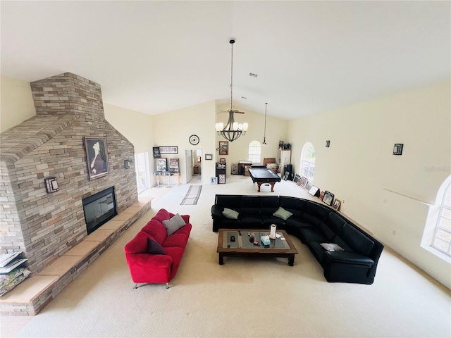 7941 Sycamore Dr, New Port Richey, FL 34654 - living area featuring a chandelier, carpet, a large fireplace, and high vaulted ceiling