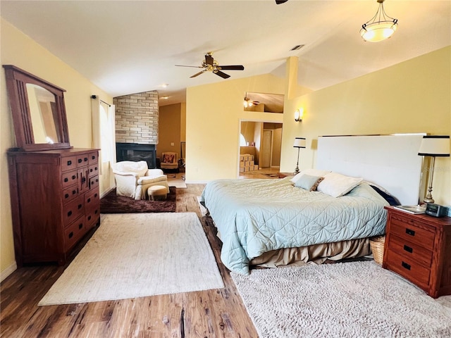 7941 Sycamore Dr, New Port Richey, FL 34654 - bedroom with lofted ceiling, wood finished floors, and a stone fireplace