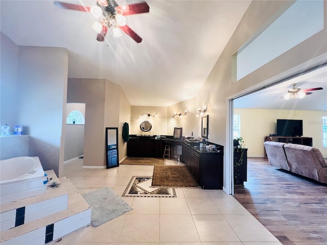 7941 Sycamore Dr, New Port Richey, FL 34654 - full bathroom with a ceiling fan, vanity, a garden tub, tile patterned floors, and vaulted ceiling