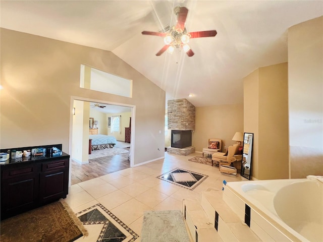 7941 Sycamore Dr, New Port Richey, FL 34654 - tiled living area with ceiling fan, a fireplace, and high vaulted ceiling