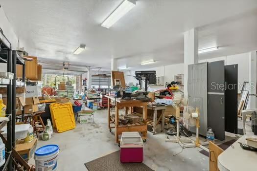 7941 Sycamore Dr, New Port Richey, FL 34654 - misc room featuring concrete floors and a workshop area
