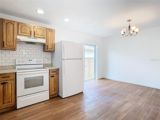 kitchen featuring white appliances, an inviting chandelier, decorative backsplash, decorative light fixtures, and light hardwood / wood-style floors