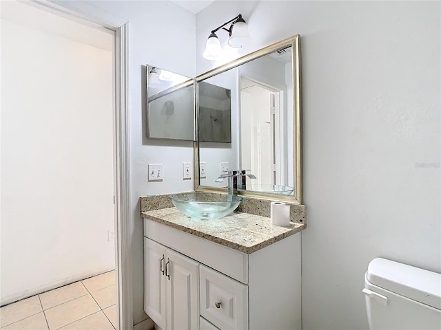 bathroom featuring tile patterned floors, vanity, and toilet