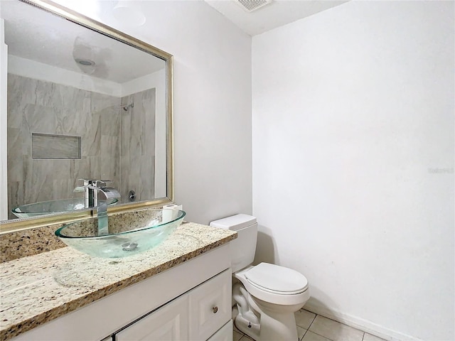 bathroom with tile patterned floors, vanity, and toilet