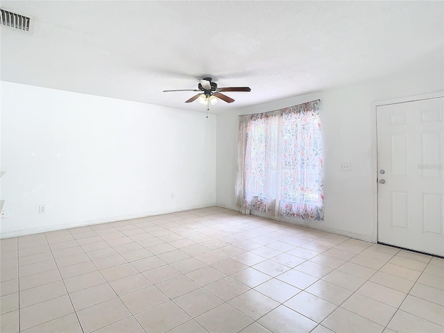 tiled empty room with ceiling fan