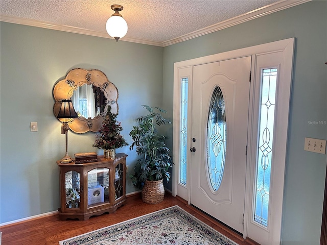 foyer entrance featuring wood-type flooring, a textured ceiling, and ornamental molding