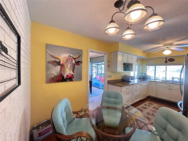 kitchen featuring white cabinets, ceiling fan, and a textured ceiling