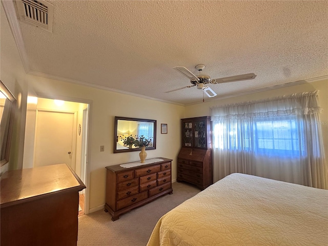 carpeted bedroom featuring ceiling fan, crown molding, and a textured ceiling