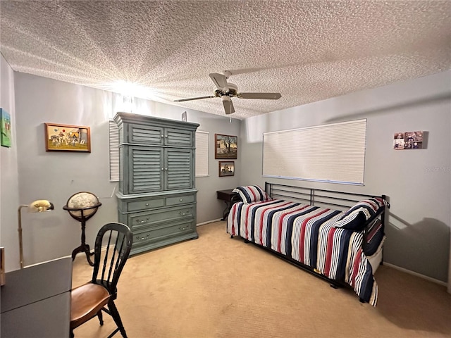 carpeted bedroom with ceiling fan and a textured ceiling