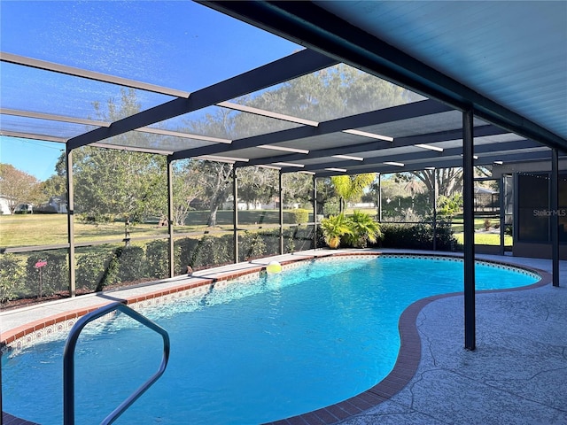 view of pool with glass enclosure