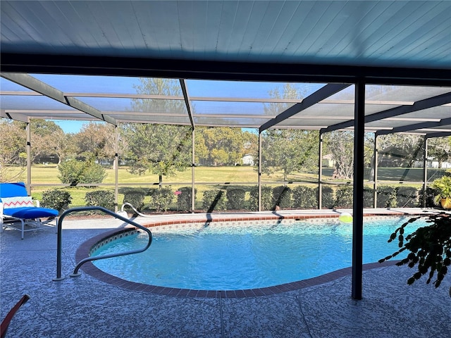 view of pool with a patio and glass enclosure