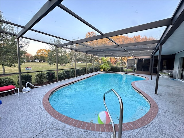 view of swimming pool with glass enclosure and a patio