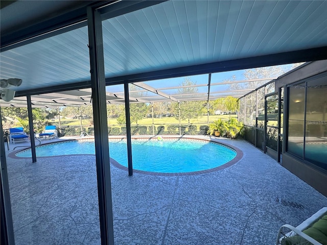 view of pool with a patio area and a lanai