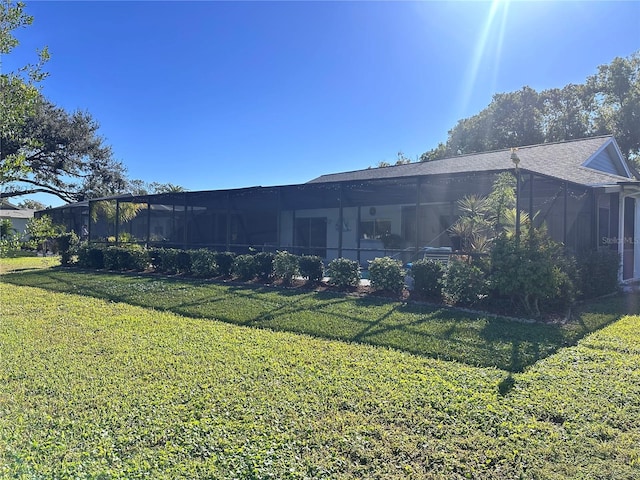 back of house with a lawn and a sunroom