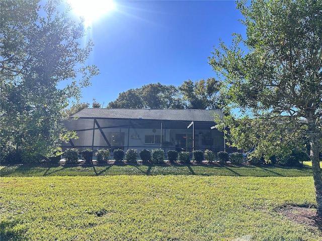 view of yard with a sunroom and glass enclosure