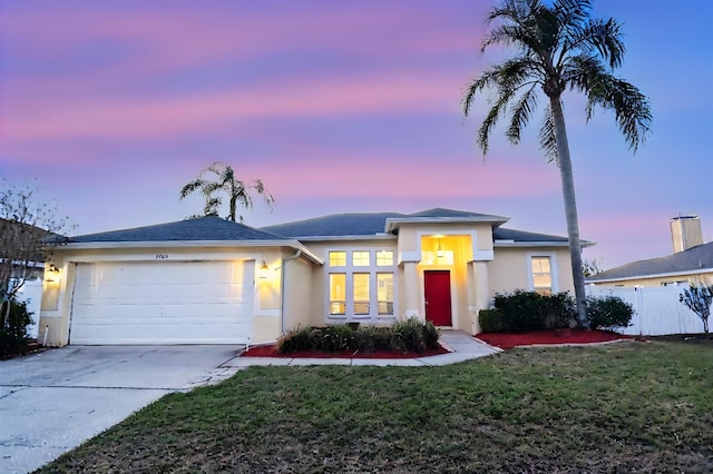 view of front of house with a yard and a garage