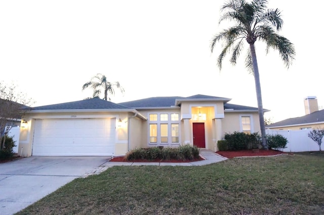 view of front facade with a garage and a front lawn