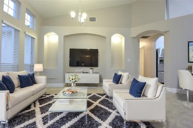 living room featuring high vaulted ceiling and an inviting chandelier