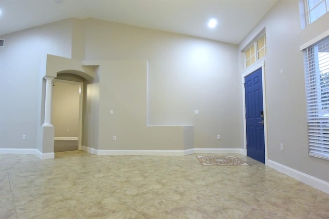 interior space featuring a high ceiling and ornate columns