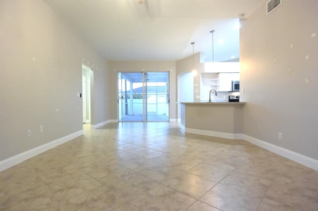 interior space with light tile patterned flooring and sink