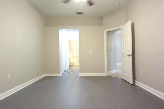 unfurnished bedroom featuring connected bathroom and ceiling fan