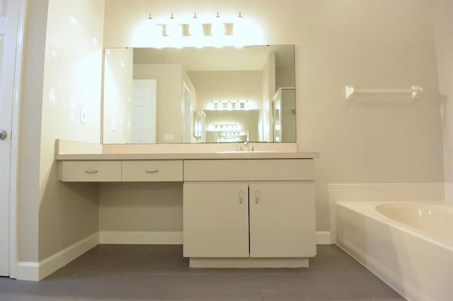 bathroom with a washtub and vanity