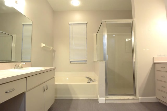 bathroom featuring vanity, hardwood / wood-style flooring, and separate shower and tub