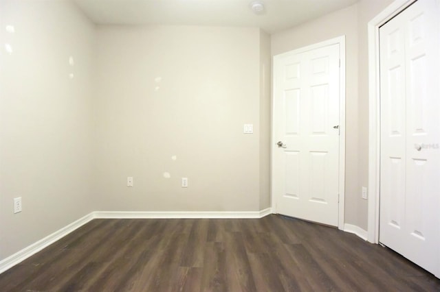 unfurnished bedroom featuring dark hardwood / wood-style flooring