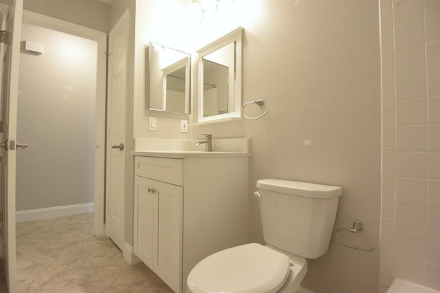 bathroom featuring tile patterned flooring, vanity, and toilet