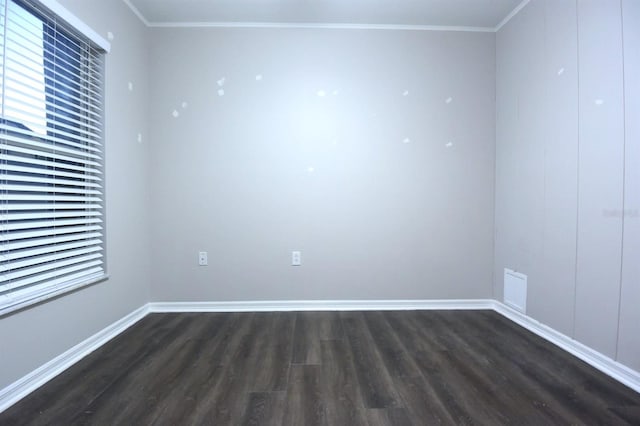 unfurnished room featuring dark hardwood / wood-style floors and ornamental molding