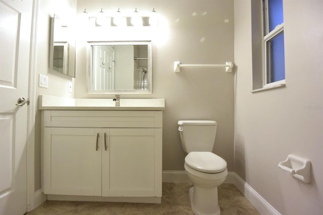 bathroom featuring tile patterned flooring, a shower, vanity, and toilet