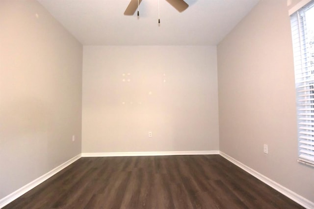 empty room with ceiling fan and dark wood-type flooring