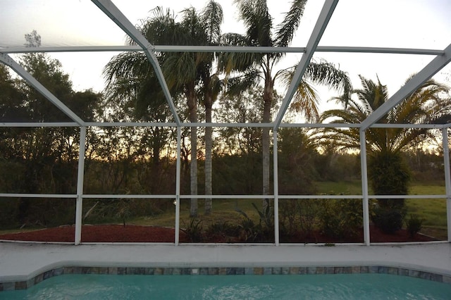 view of pool with glass enclosure