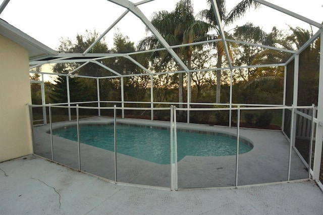 view of pool featuring a patio and glass enclosure