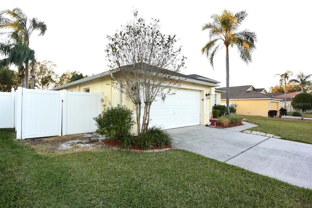 view of side of property featuring a lawn and a garage