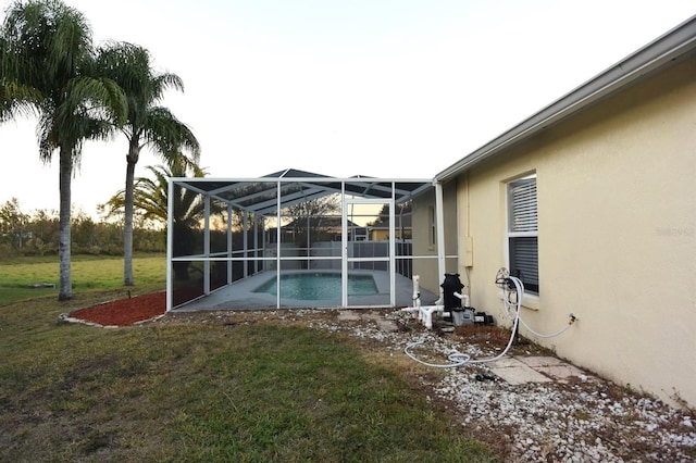 exterior space with a fenced in pool and glass enclosure