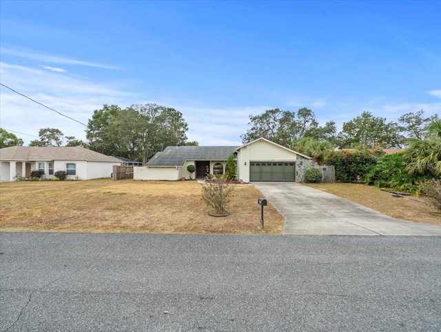 ranch-style home with a front yard and a garage