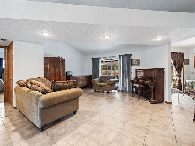 tiled living room featuring lofted ceiling and a textured ceiling