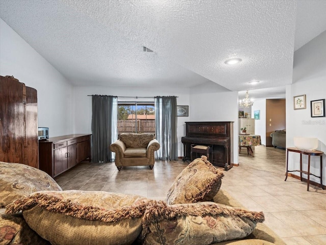 tiled living room with a fireplace, a chandelier, and a textured ceiling