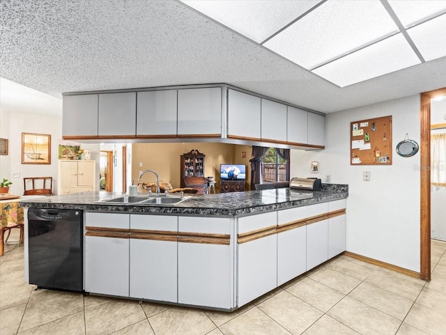 kitchen with dishwasher, sink, light tile patterned floors, kitchen peninsula, and white cabinets