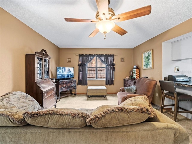 tiled living room with ceiling fan and a textured ceiling