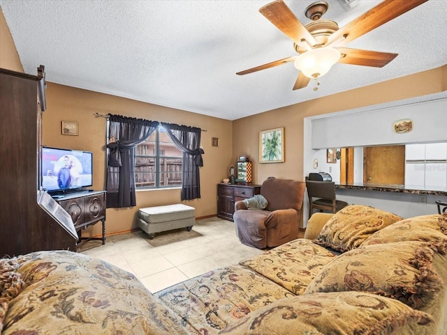 tiled living room featuring a textured ceiling and ceiling fan