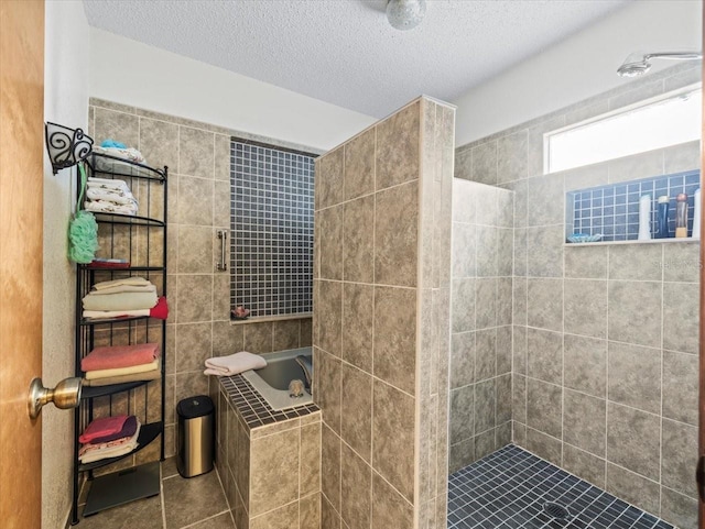 bathroom with tile patterned flooring, a textured ceiling, and independent shower and bath