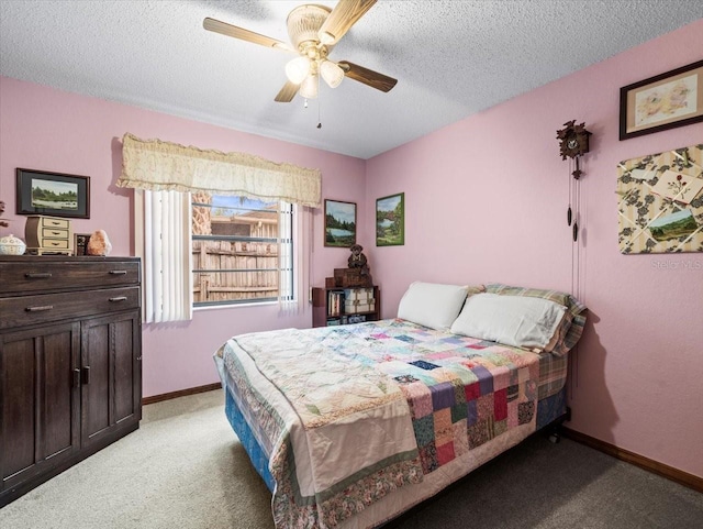 bedroom featuring light carpet, a textured ceiling, and ceiling fan