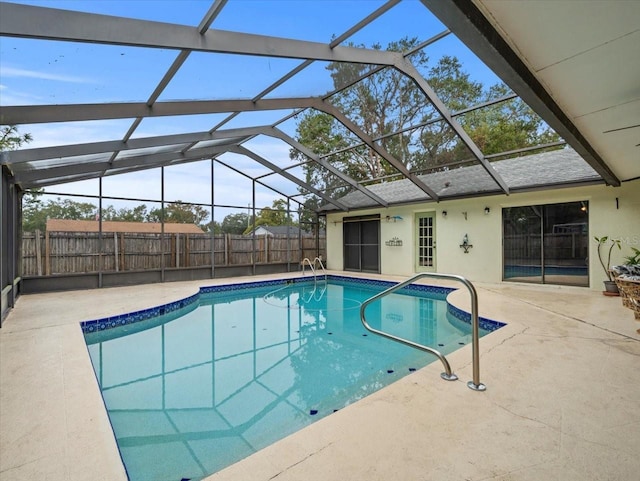 view of swimming pool featuring a patio area and a lanai