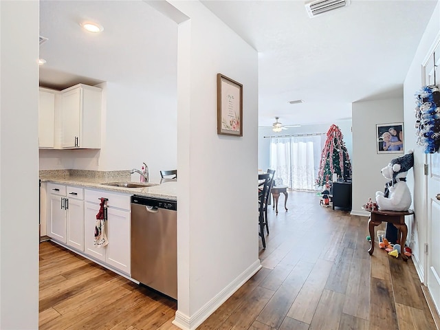 hallway with light hardwood / wood-style flooring and sink