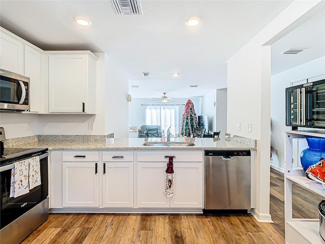 kitchen featuring white cabinetry, stainless steel appliances, light hardwood / wood-style floors, and sink