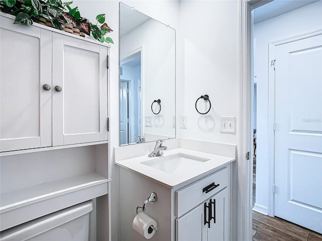 bathroom with vanity, wood-type flooring, and toilet